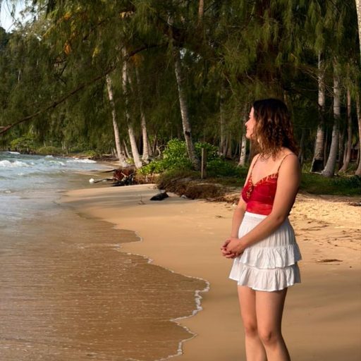Woman gazing across the sea at Koh Rong island, Cambodia.