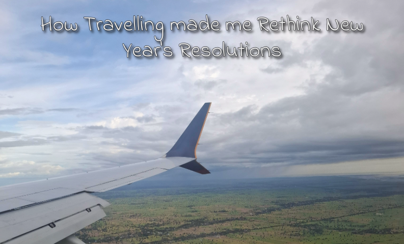 View from an airplane window while travelling, reflecting on how travel changed my perspective on New Year’s resolutions and personal goals.