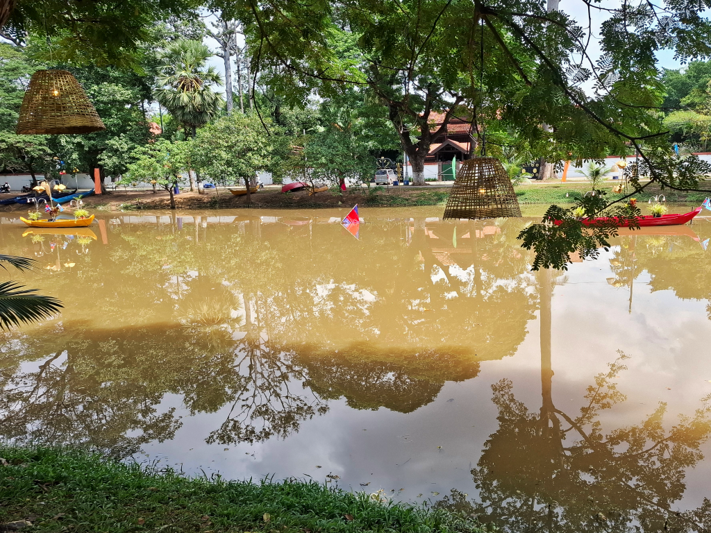 Bright kayaks floating along the river in Siem Reap.