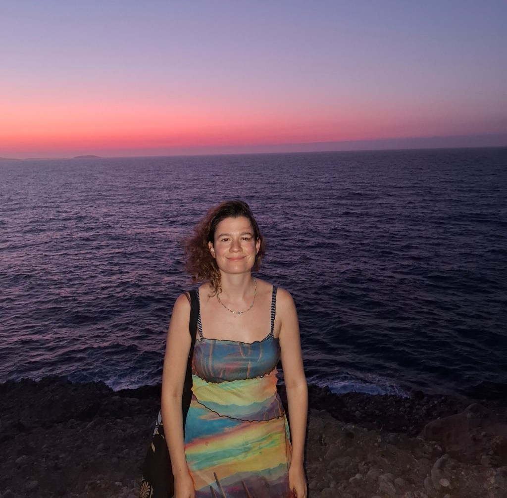 Woman in Naxos, against a sunset.