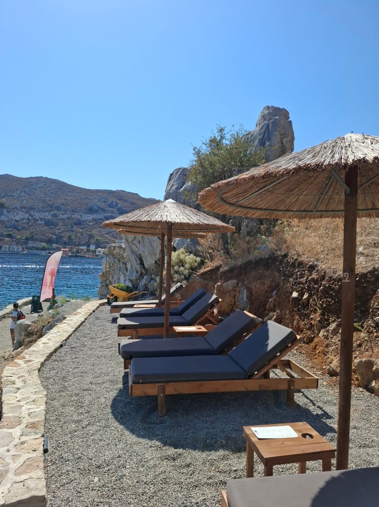 A peaceful beach situated in Symi, Greece.